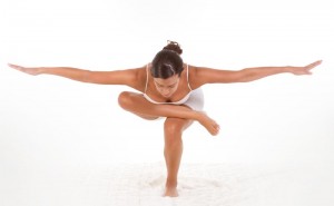 yoga pose - female in sport clothes performing exercise